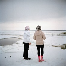 Two girls watching the ice break in spring, Salekhard, 2015