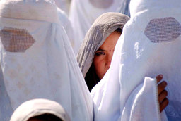 A girl waiting for food provisions at a refugee camp in Northern Afghanistan, September 2001