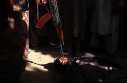 A dead Taliban soldier lay in the streets of Kunduz, the day the city fell to Northern Alliance forces, North Afghanistan, November 2001