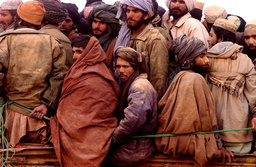 Taliban prisoners squeezed onto a truck in the desert, North Afghanistan, November 2001