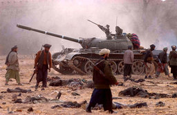 Northern Alliance troops walked through a carpet of Taliban corpses, Mazar–i–Sharif, North Afghanistan, November 2001