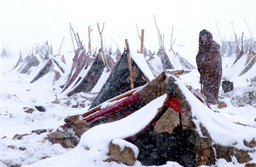 A refugee stood outside his tent as the first winter snow fell in Mazar–i–Sharif, North Afghanistan, December 2001