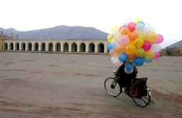 A balloon seller cycled through the streets of Kabul, Afghanistan, December 2001